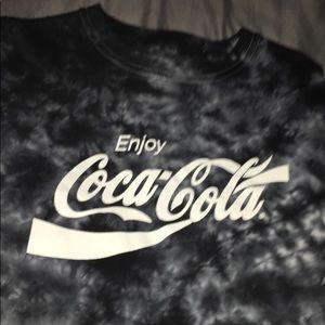 a faded off black and white coca cola shirt